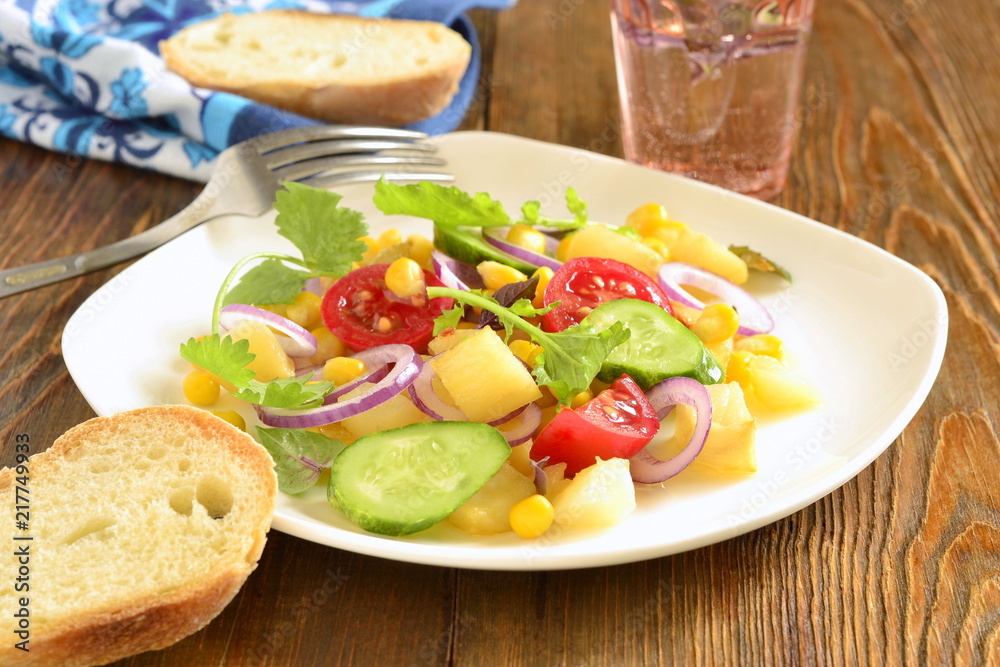 Salad with corn, fresh vegetables and baked potatoes