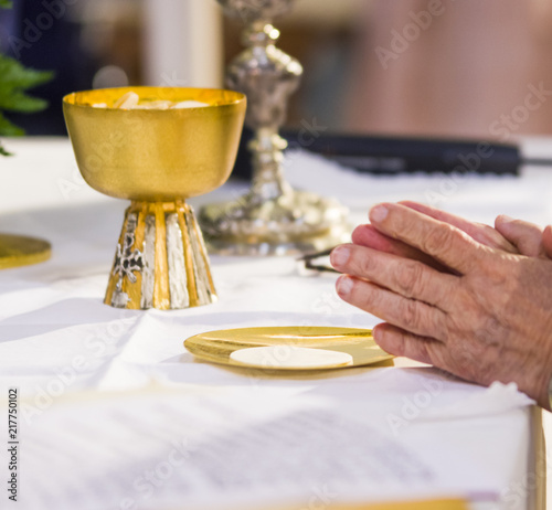 the hands of the Pope consecrate the host, the holy bread in the body of Christ photo