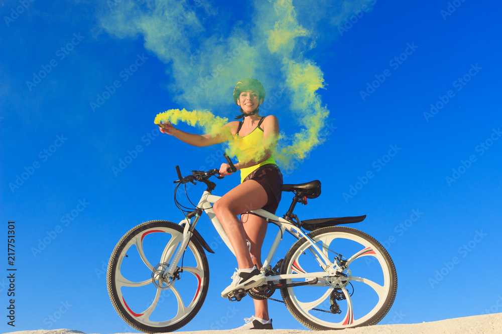 Woman on a bicycle against the blue sky Woman on a bicycle against the blue sky