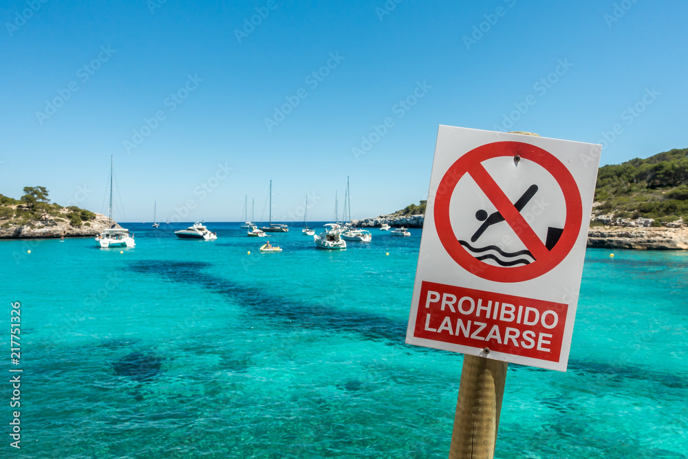 Warning sign on the beach Cala Mondrago on the island of Mallorca Warning sign on the beach Cala Mondrago on the island of Mallorca