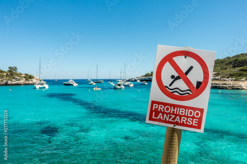 Warning sign on the beach Cala Mondrago on the island of Mallorca