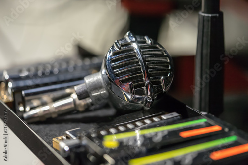 Vintage microphone with some harmonicas on the side photo