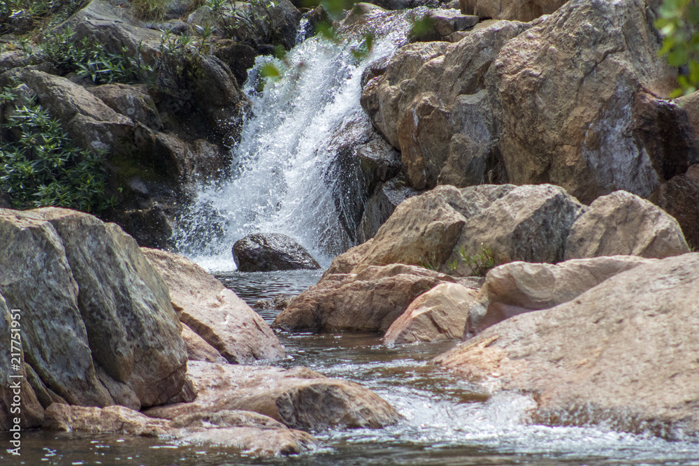 river with a waterfall in the middle of stones river with a waterfall in the middle of stones
