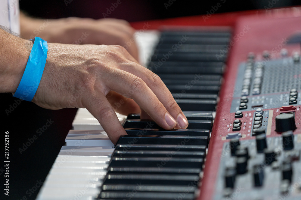 Obraz premium Hands of a musician on a red keyboard