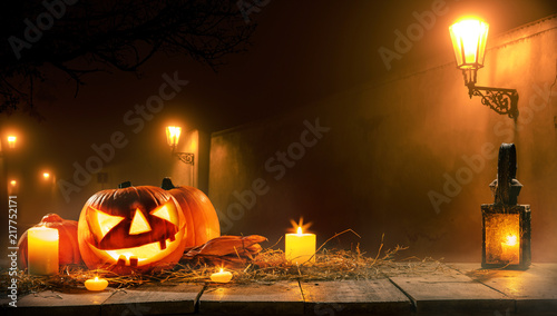 Scary horror background with halloween pumpkin jack o lantern photo