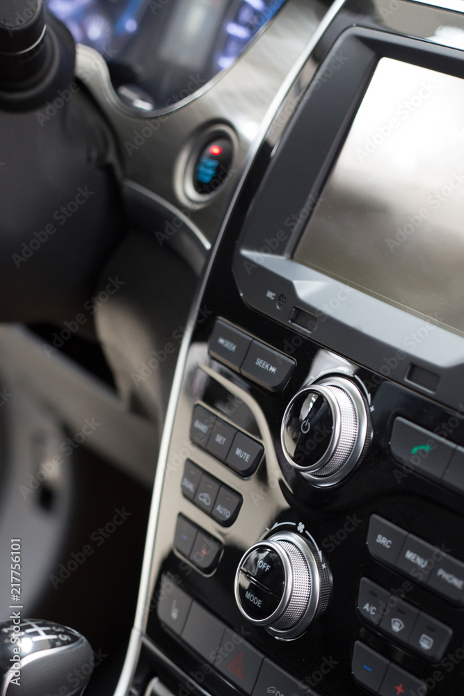 Car interior. Modern car illuminated dashboard. Luxurious car instrument cluster. Close up shot of car instrument panel. Modern car interior dashboard.