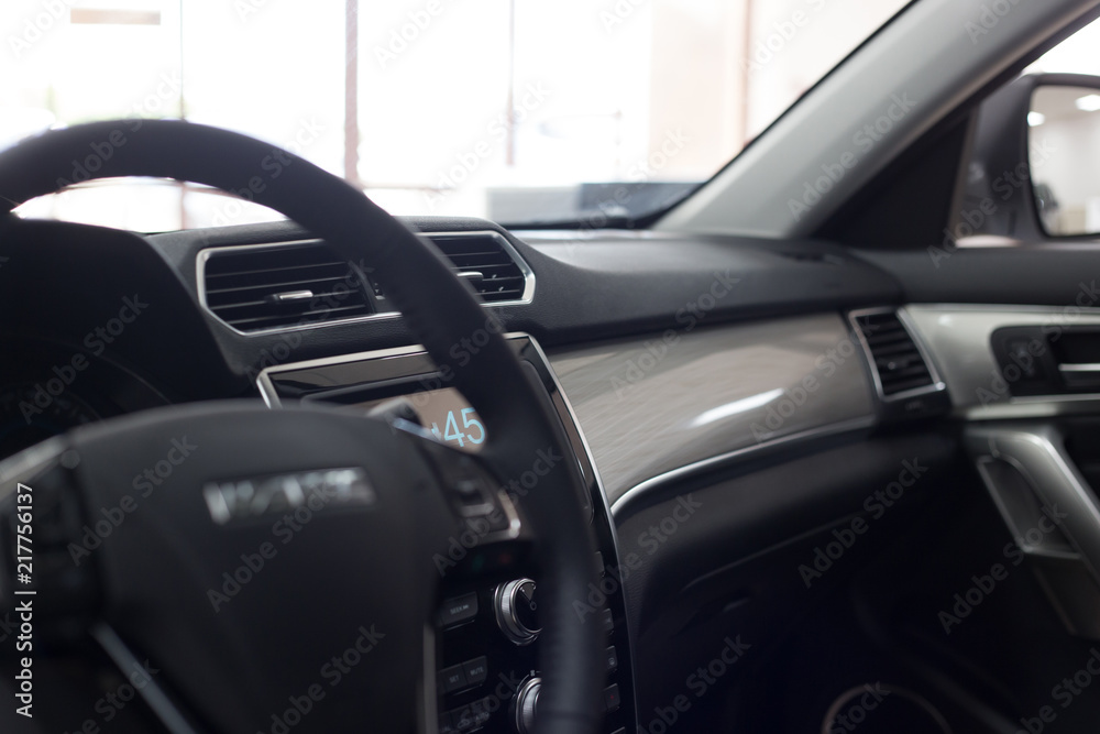 Car interior. Modern car illuminated dashboard. Luxurious car instrument cluster.  Modern car interior dashboard and steering wheel