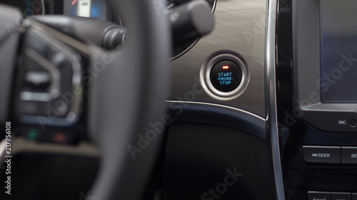 Start, stop engine button. Modern car interior. Luxurious car instrument cluster. Close up shot of car instrument panel.