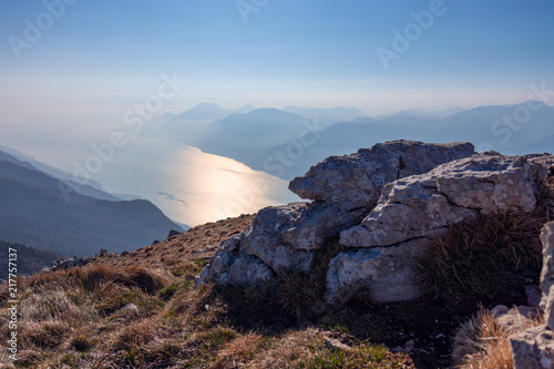 background composition of stones and a view of Lake Garda