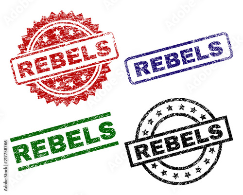 REBELS seal prints with distress surface. Black, green,red,blue vector rubber prints of REBELS text with unclean style. Rubber seals with circle, rectangle, rosette shapes. photo