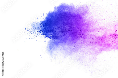 Abstract blue-purple dust explosion on white background. Freeze motion of blue-pink powder splashing.