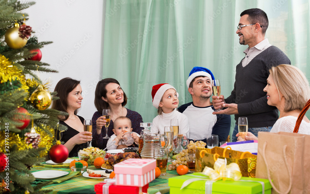 Cheerful Mature parents with kids celebrating Merry Christmas