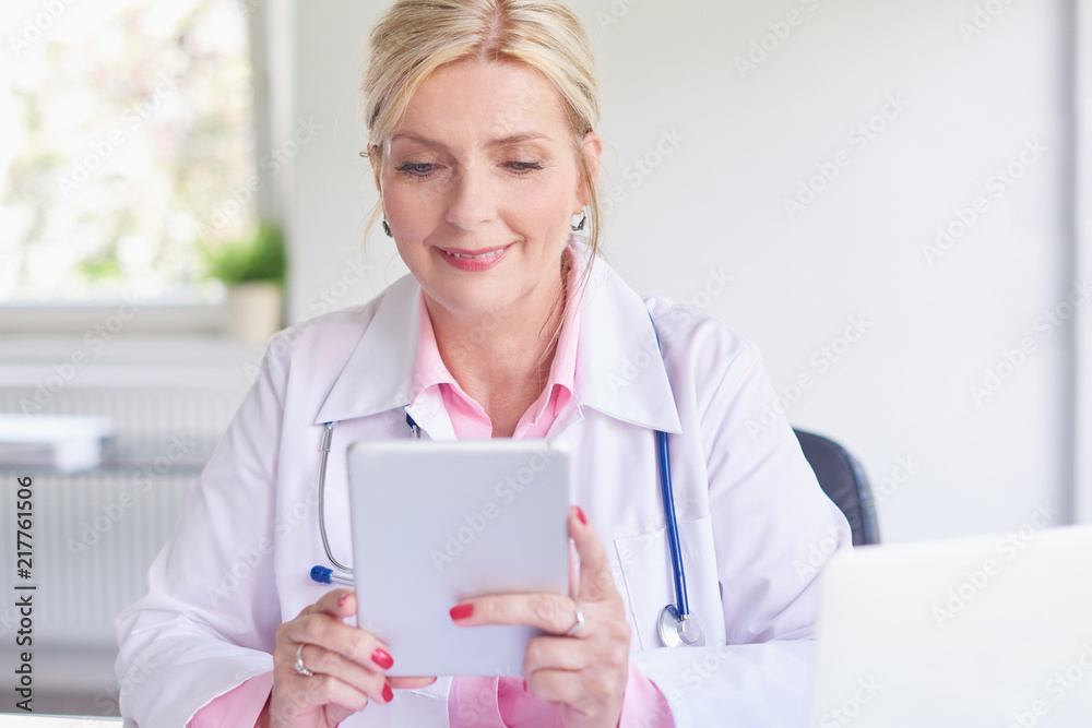 Female doctor using toucpad at the private clinic Female doctor using toucpad at the private clinic