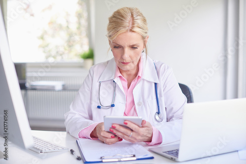 Female doctor using toucpad at the private clinic