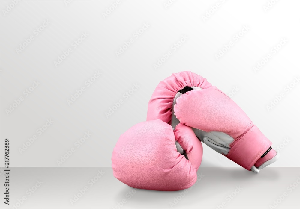 Pink boxing gloves on desk