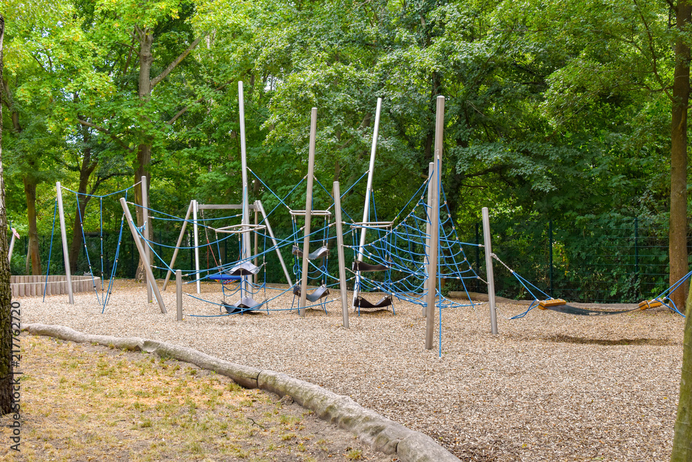 Climbing frame with equipment out of ropes, metal poles and other elements on a public playground in Berlin. Climbing frame with equipment out of ropes, metal poles and other elements on a public playground in Berlin.
