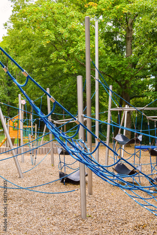 Climbing frame with equipment out of ropes, metal poles and other elements on a public playground in Berlin. Climbing frame with equipment out of ropes, metal poles and other elements on a public playground in Berlin.