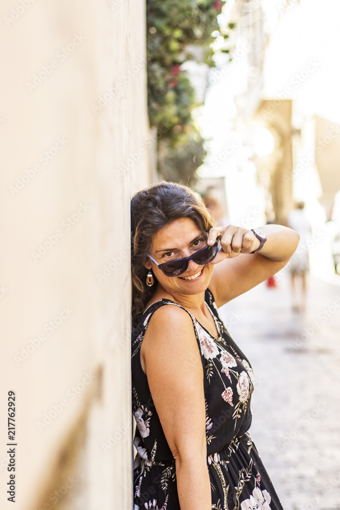 Middle aged woman on the streetwith a sunglasses