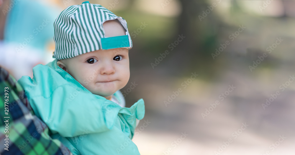 cute baby boy in a cap and jacket. outdoor portrait. copyspace cute baby boy in a cap and jacket. outdoor portrait. copyspace