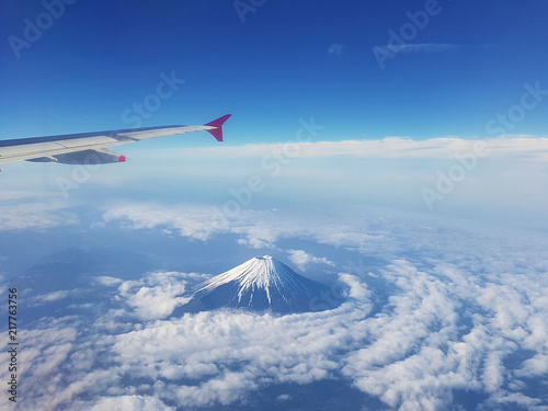 Top view of fuji mountain and wing of the air plane from window airplane with an Aerial view background, Yamanashi, Japan