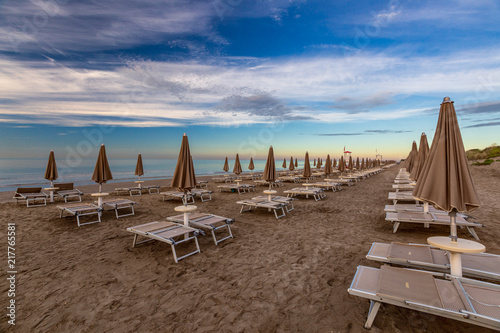 Morning on the beach with empty chaise lounges © sokko_natalia