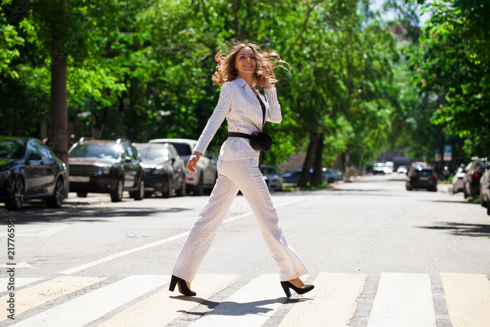 Young happy brunette woman in white business suit Young happy brunette woman in white business suit