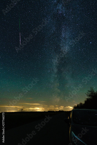 Perseides shooting star over northern lights. photo