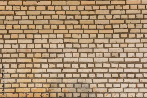 Wall from yellow bricks background texture abstract