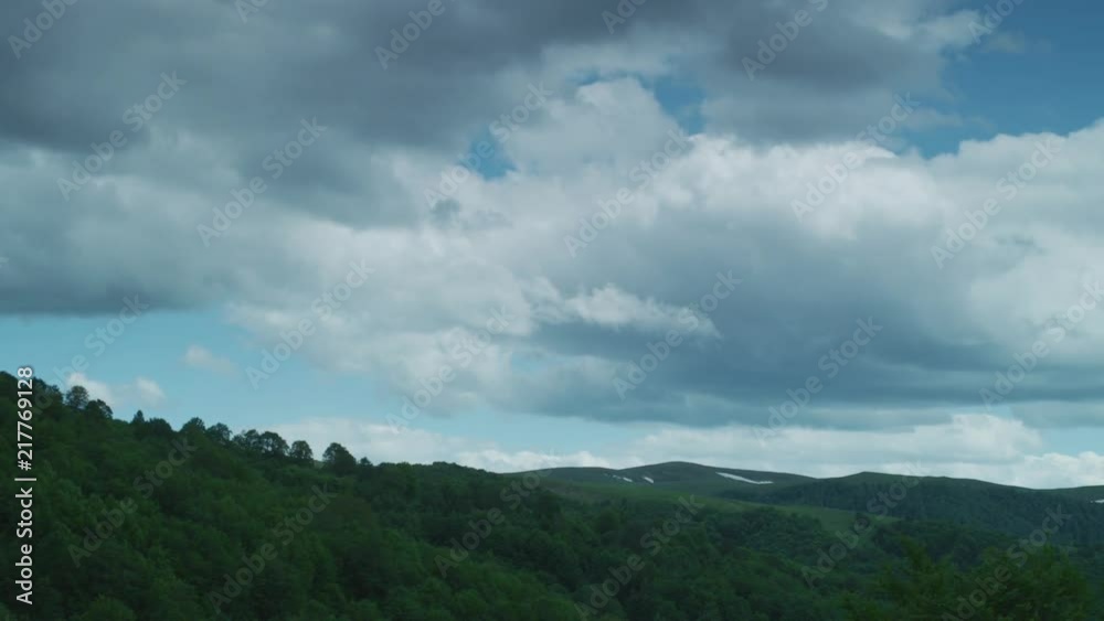 White clouds rolling above the mountains. A timelapse. White clouds rolling above the mountains. A timelapse.
