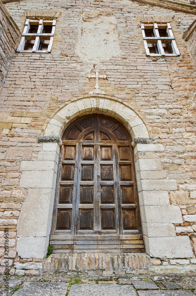 Stone cross with ancient main door