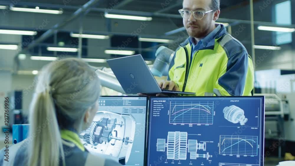 At the Factory: Male and Female Mechanical Engineers Use Laptop and ...