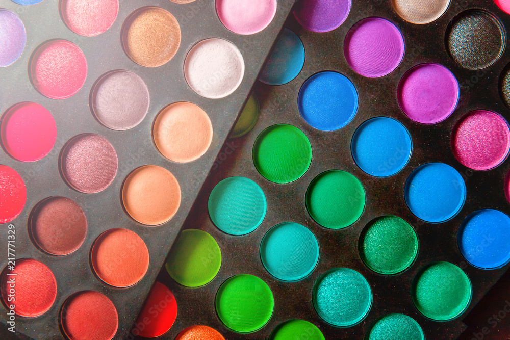 Tools for makeup and cosmetics different shades of eyeshadow palette and make up brush on trendy colorful blue pastel background. Top view flat lay and picturesque Tools for makeup and cosmetics different shades of eyeshadow palette and make up brush on trendy colorful blue pastel background. Top view flat lay and picturesque