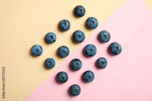 Flat lay composition with tasty blueberry on color background