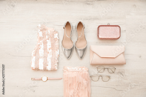 Flat lay composition with stylish outfit for woman on wooden background
