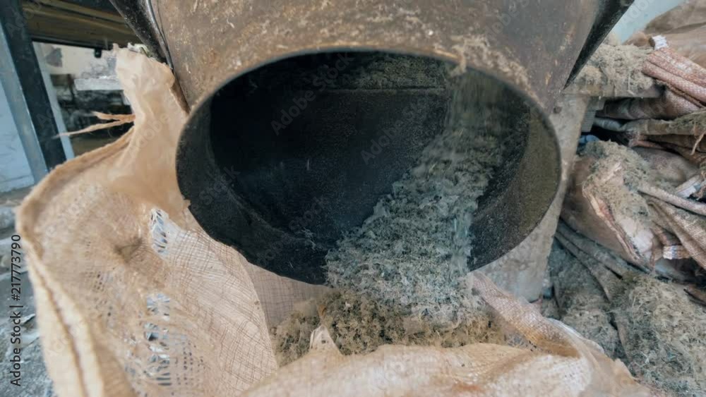 Milled wastepaper in a bag, close up. Milled wastepaper in a bag, close up.