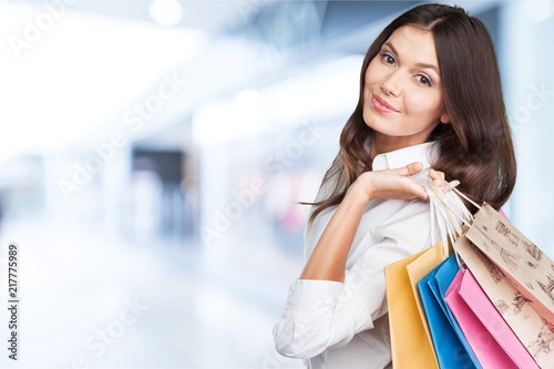 Young woman with shopping bags on blurred