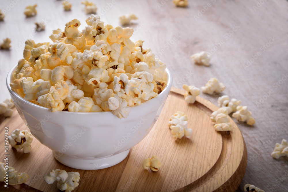 Salt popcorn on the wooden table, selective focus Salt popcorn on the wooden table, selective focus