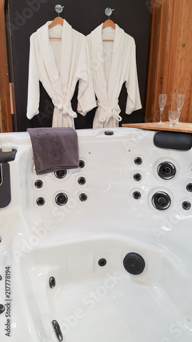 beautiful white wellness center with spa whirlpool bath with white bathrobes for a couple