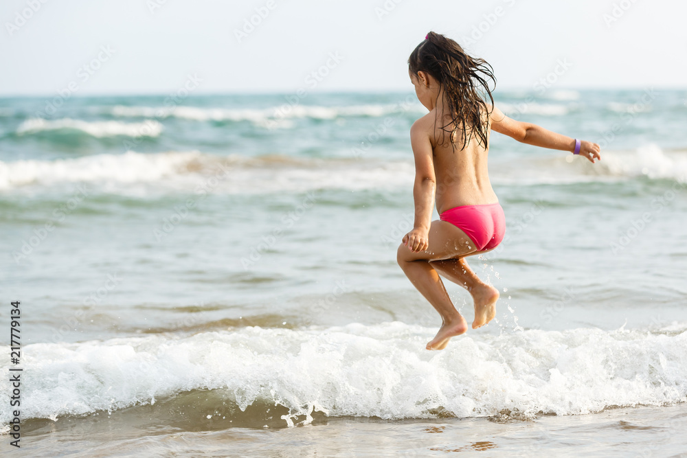 flying jump beach girl on blue sea shore in summer vacation