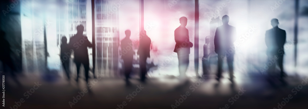 Silhouettes of people walking in the street near skyscrapers and modern office buildings. Multiple exposure blurred image. Economy, finances, business concept illustration. Conseptual. 