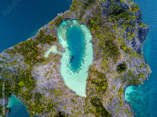 Aerial drone view of a beautiful coral lagoon inside a remote tropical island (Shark Lagoon, Cock Comb Island, Myanmar) photo