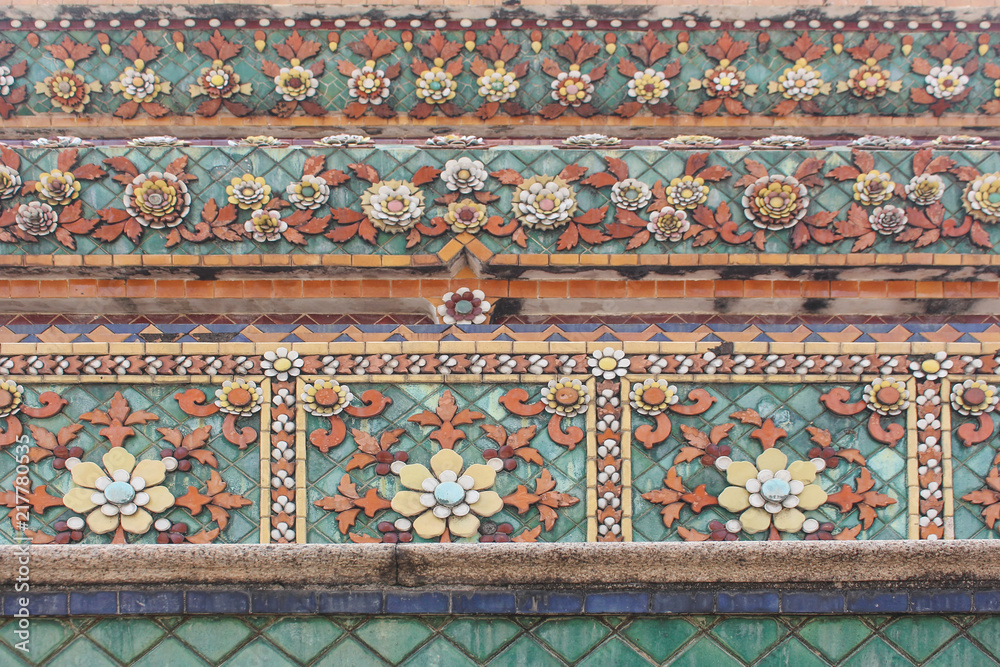 Flower details in Chedi of Wat Pho temple in Bangkok, Thailand.