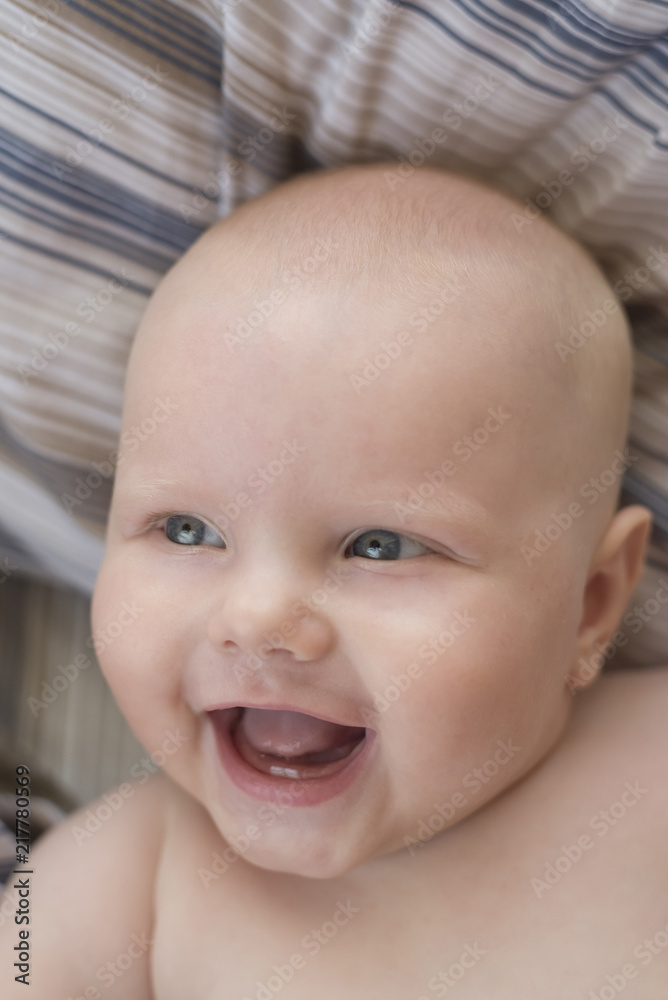 Portrait of a cute naked smiling baby with two first teeth Portrait of a cute naked smiling baby with two first teeth