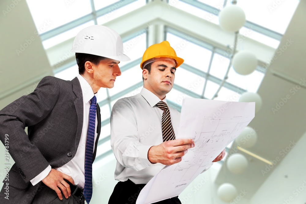Two engineers men at construction site watching Two engineers men at construction site watching
