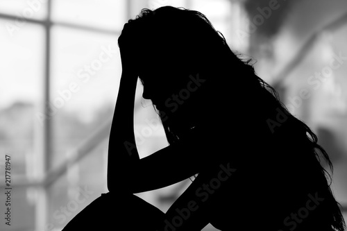 Canvas Print Young woman crying on background