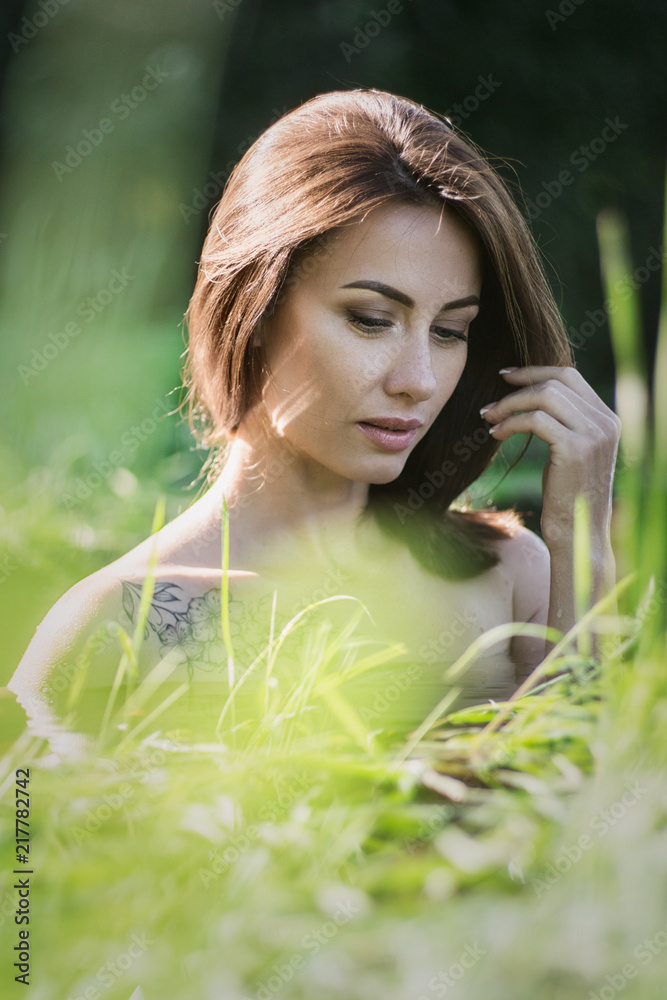 Young brunette woman natural portrait outdoors in water, shallow depth of field Young brunette woman natural portrait outdoors in water, shallow depth of field