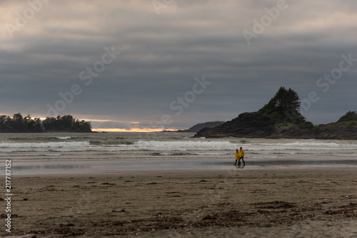 People walking on the beach on a spring afternoon at Cox beach, Vancouver Island