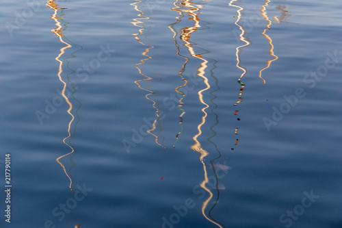 Water reflections. Reflection of Felucca Sailing boats on the clean water of the Nile River in Aswan, Egypt