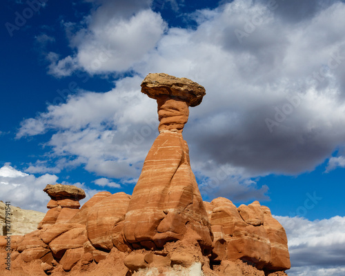 Red Toadstool hoodoo formation, in Southern Utah's badlands. Blue sky and clouds are in the background. In the Paria Rimrocks, Grand Staircase-Escalante National Monument.  photo