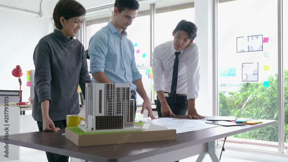 Architects team are working on paper blueprint and building model. Business woman suggest idea to designer. concept of construction, architecture, development and creative.